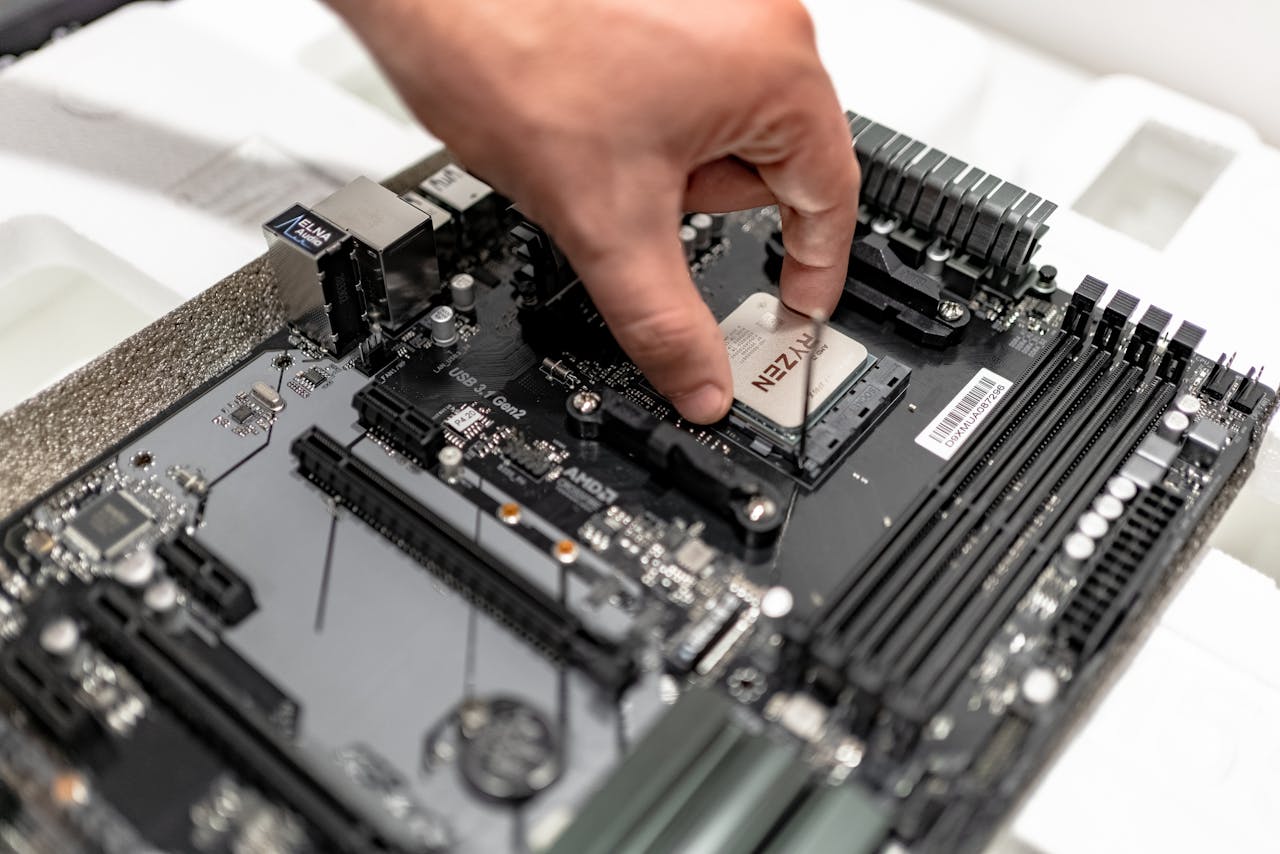 Features Person's hand installing a CPU on a motherboard, showcasing PC maintenance and repair.